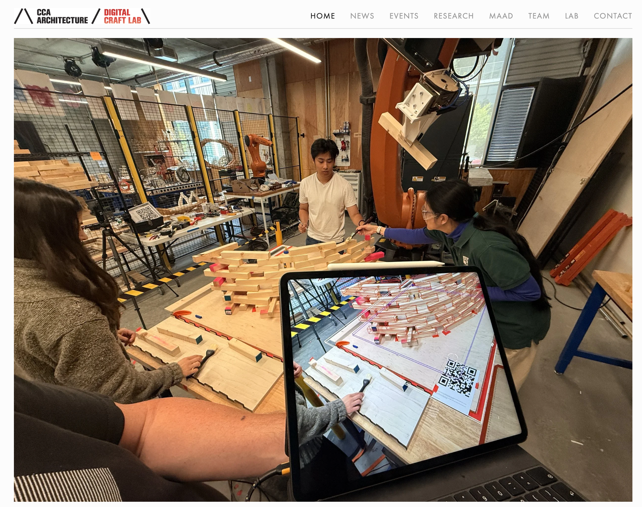 Three students work on a curved wooden structure in a lab while a laptop records what they are doing